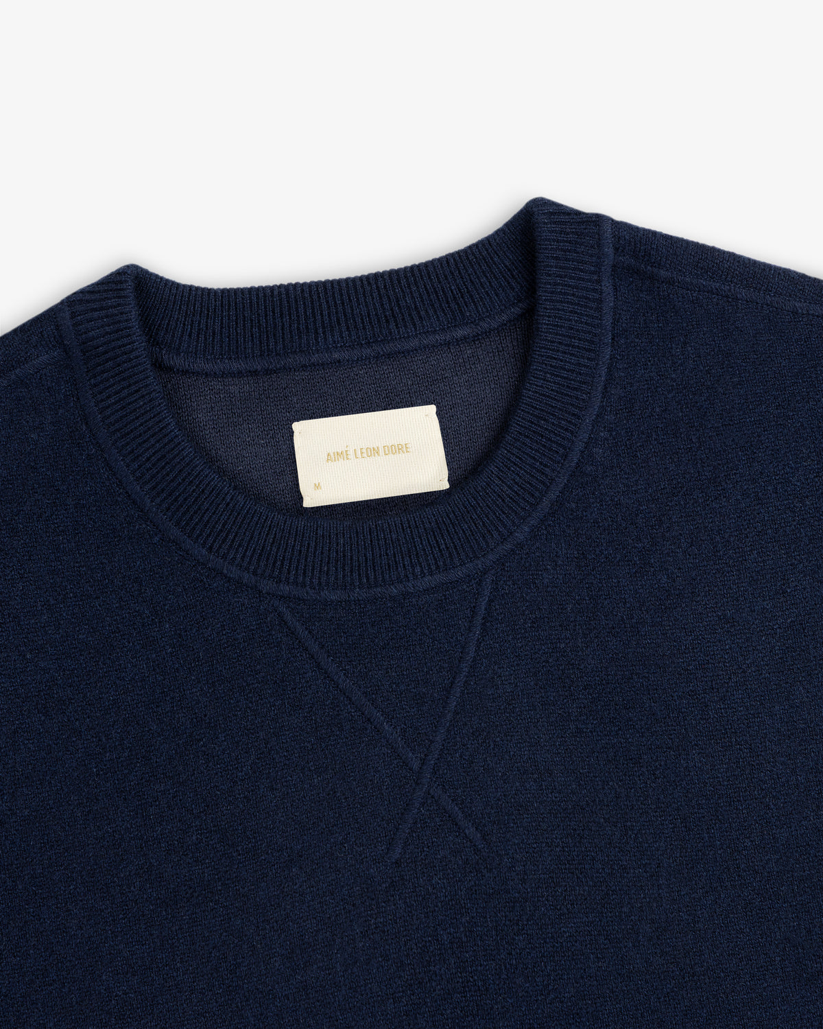 Navy Pavilion Cashmere Crewneck Sweatshirt with ribbed collar and visible Aime Leon Dore label.
