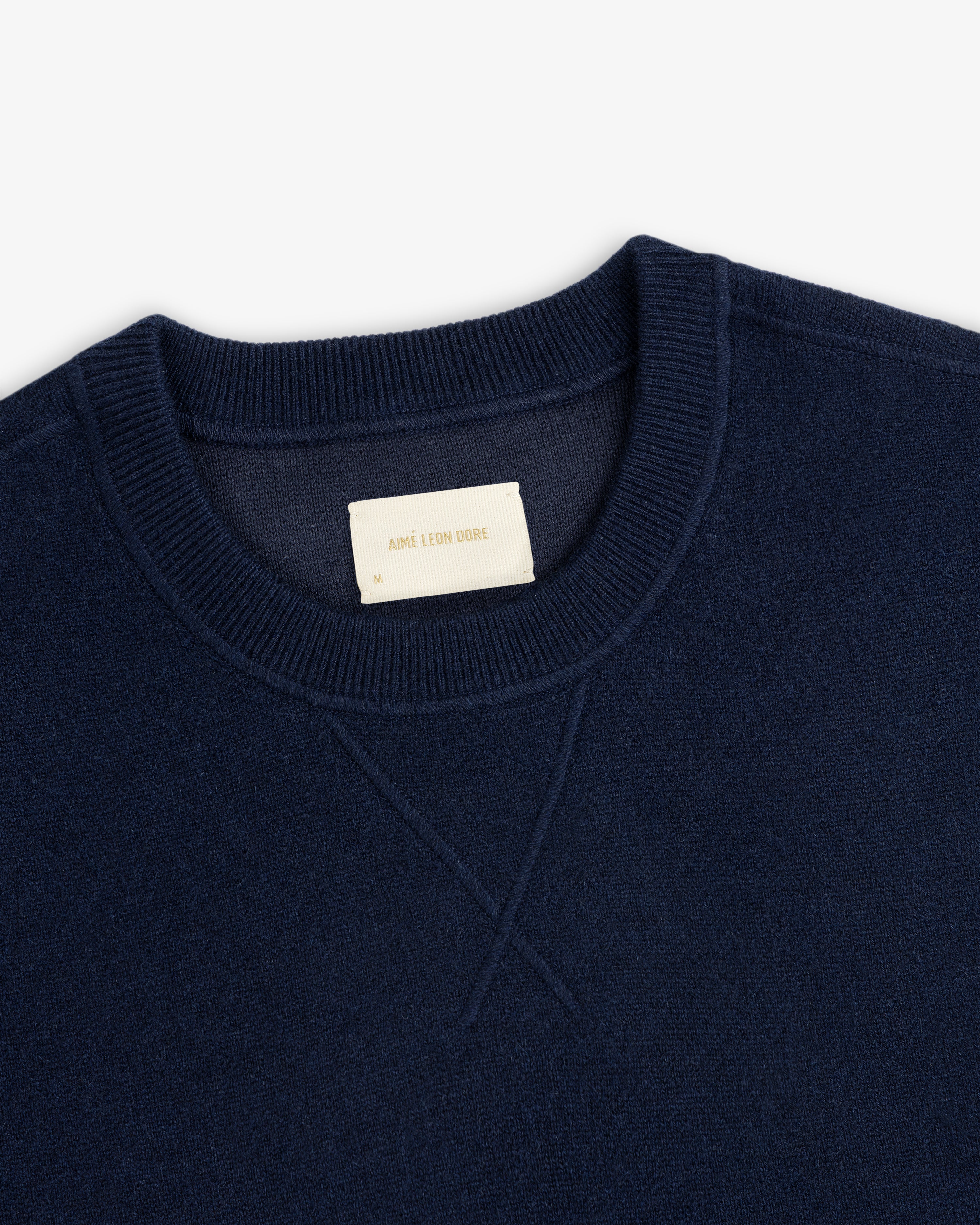 Navy Pavilion Cashmere Crewneck Sweatshirt with ribbed collar and visible Aime Leon Dore label.