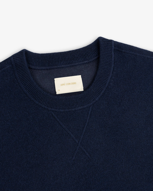 Navy Pavilion Cashmere Crewneck Sweatshirt with ribbed collar and visible Aime Leon Dore label.