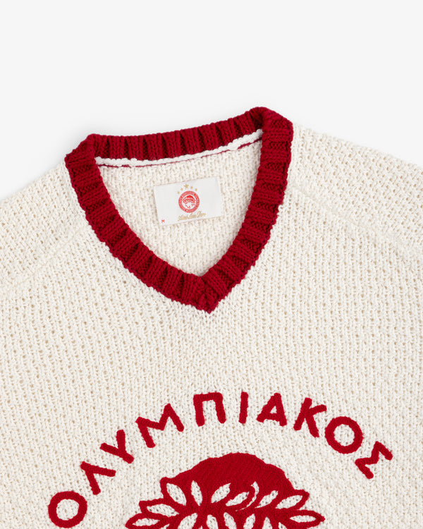 ALD / Olympiacos F.C. Knit V-Neck Sweater in cream with a red ribbed collar and red Greek lettering across the chest.