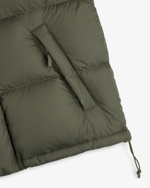 Close-up of the olive ALD / The North Face Baltoro Jacket with slanted pocket and adjustable drawstring hem.