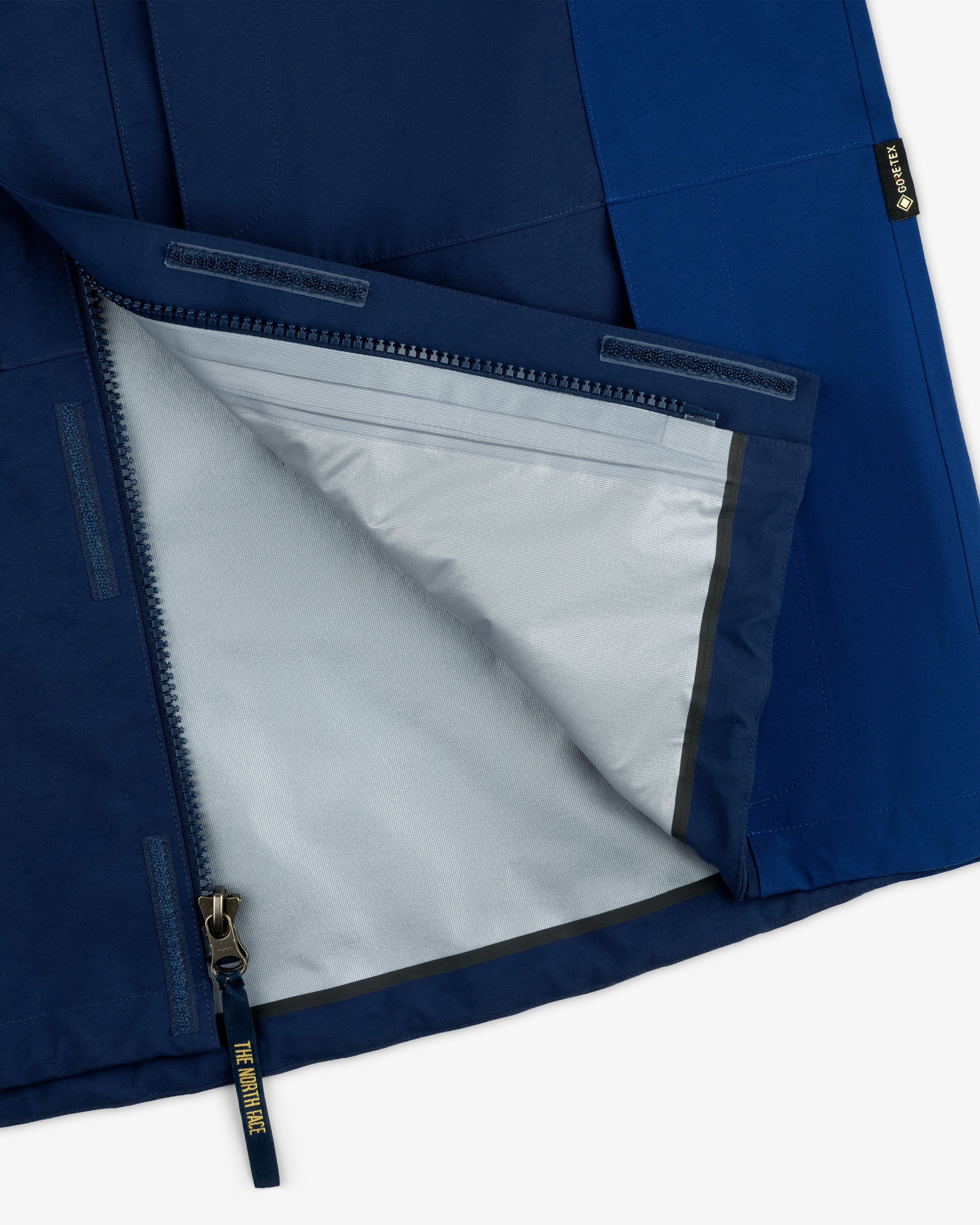 Close-up of ALD/The North Face GORE-TEX 2000 Mountain Jacket’s open zipper, showing a light gray lining.