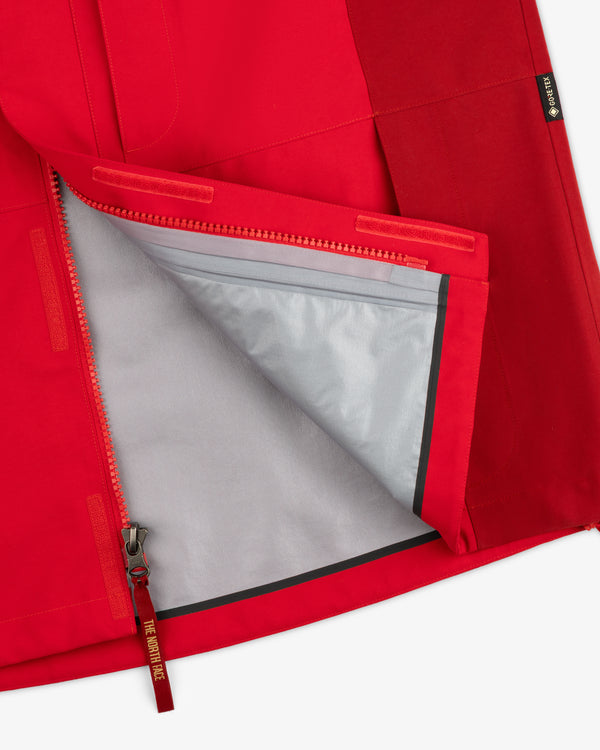 Close-up of the ALD / The North Face GORE-TEX 2000 Mountain Jacket, red, unzipped to show its gray lining.