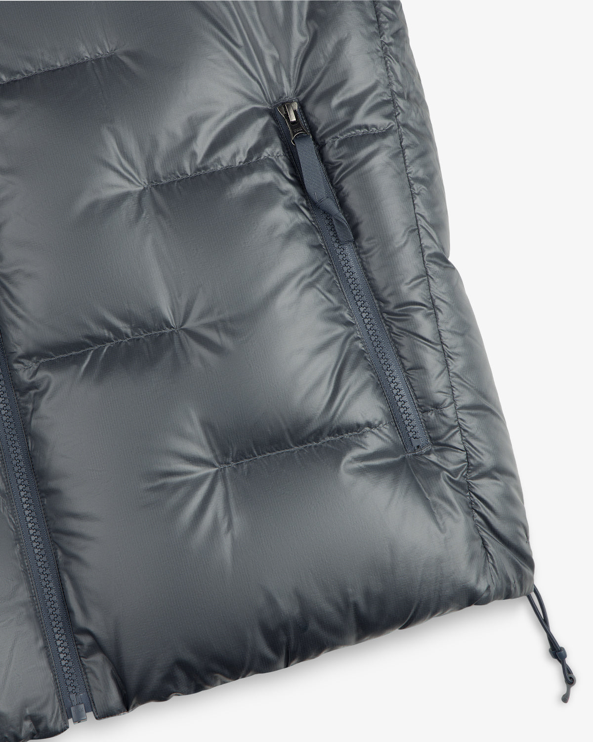 Close-up of ALD / The North Face Reversible Pertex® Nuptse Jacket with zip pocket and quilted stitching.