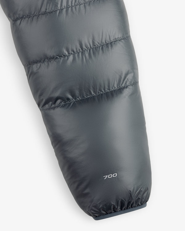 Close-up of an ALD/The North Face Reversible Pertex® Nuptse Jacket sleeve with “700” near the cuff on gray fabric.