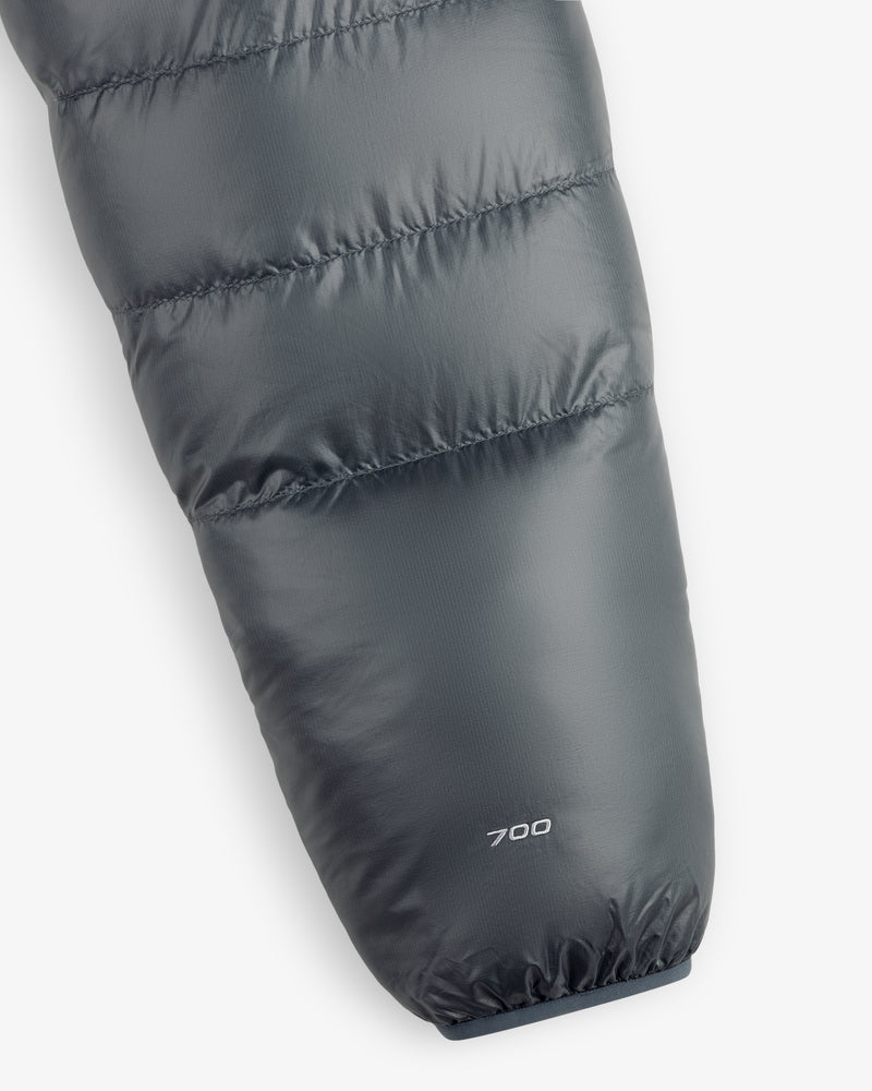 Close-up of an ALD/The North Face Reversible Pertex® Nuptse Jacket sleeve with “700” near the cuff on gray fabric.