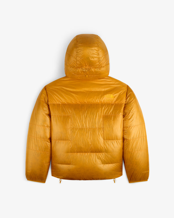 The ALD/The North Face Reversible Pertex® Nuptse Jacket in mustard yellow, hooded, shown from the back on white.
