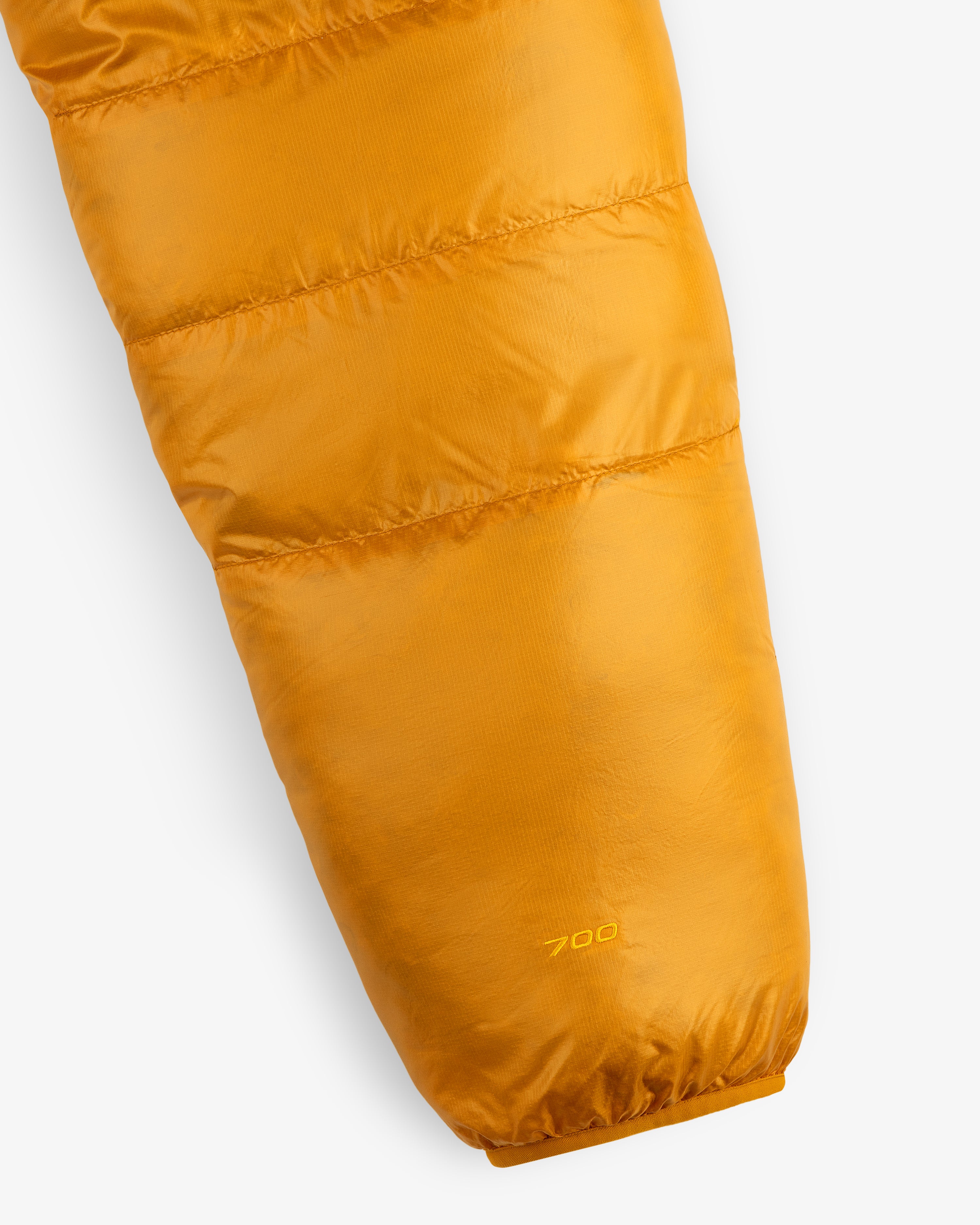 Close-up of ALD / The North Face Reversible Pertex® Nuptse Jacket sleeve with “700” stitched by the cuff.