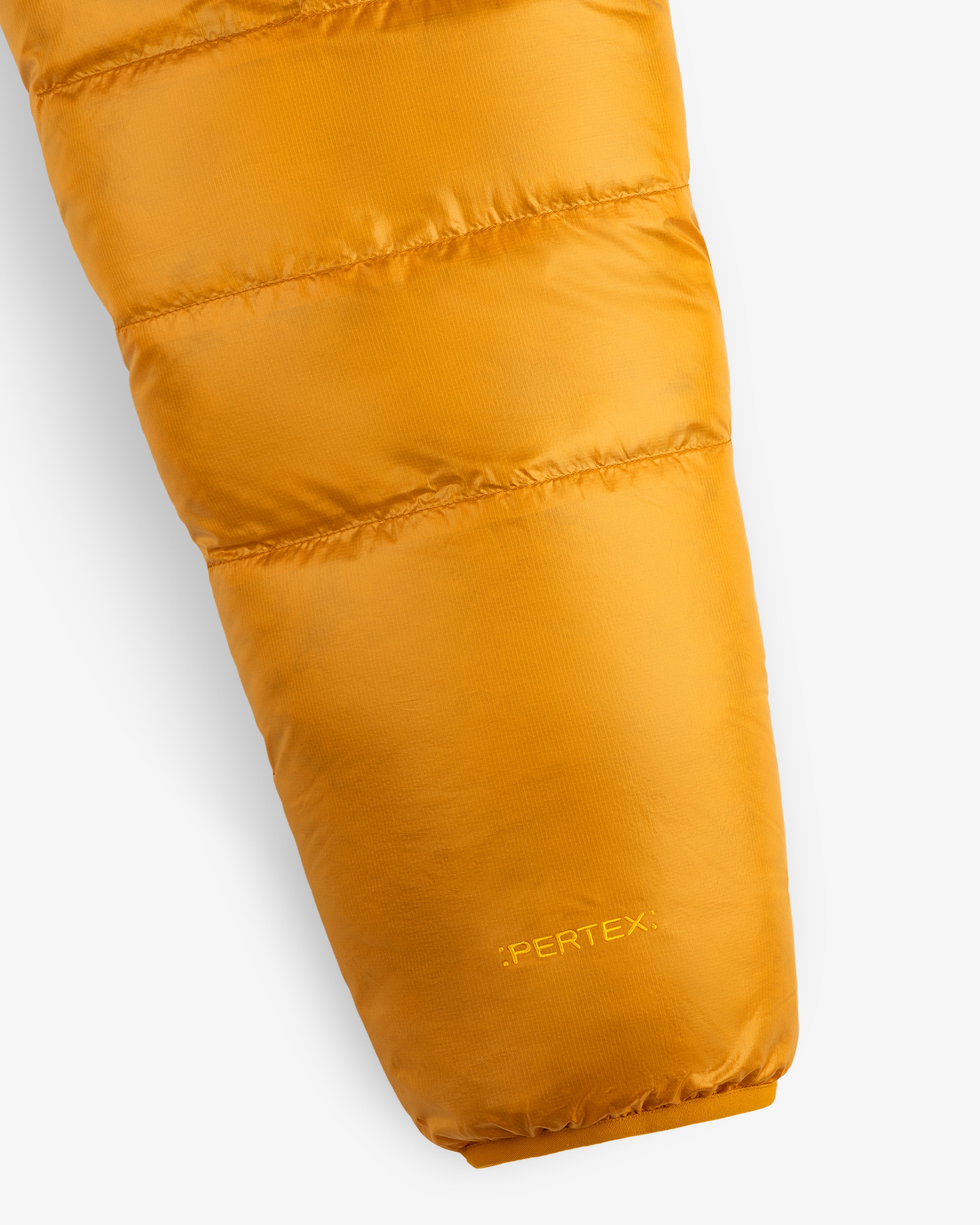 Close-up of ALD/The North Face Reversible Pertex® Nuptse Jacket sleeve with “PERTEX” near the cuff.
