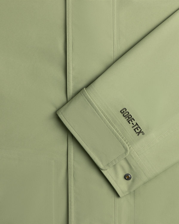 Close-up of ALD / The North Face GORE-TEX Trench Coat sleeve with branding and a metal snap button on the cuff.