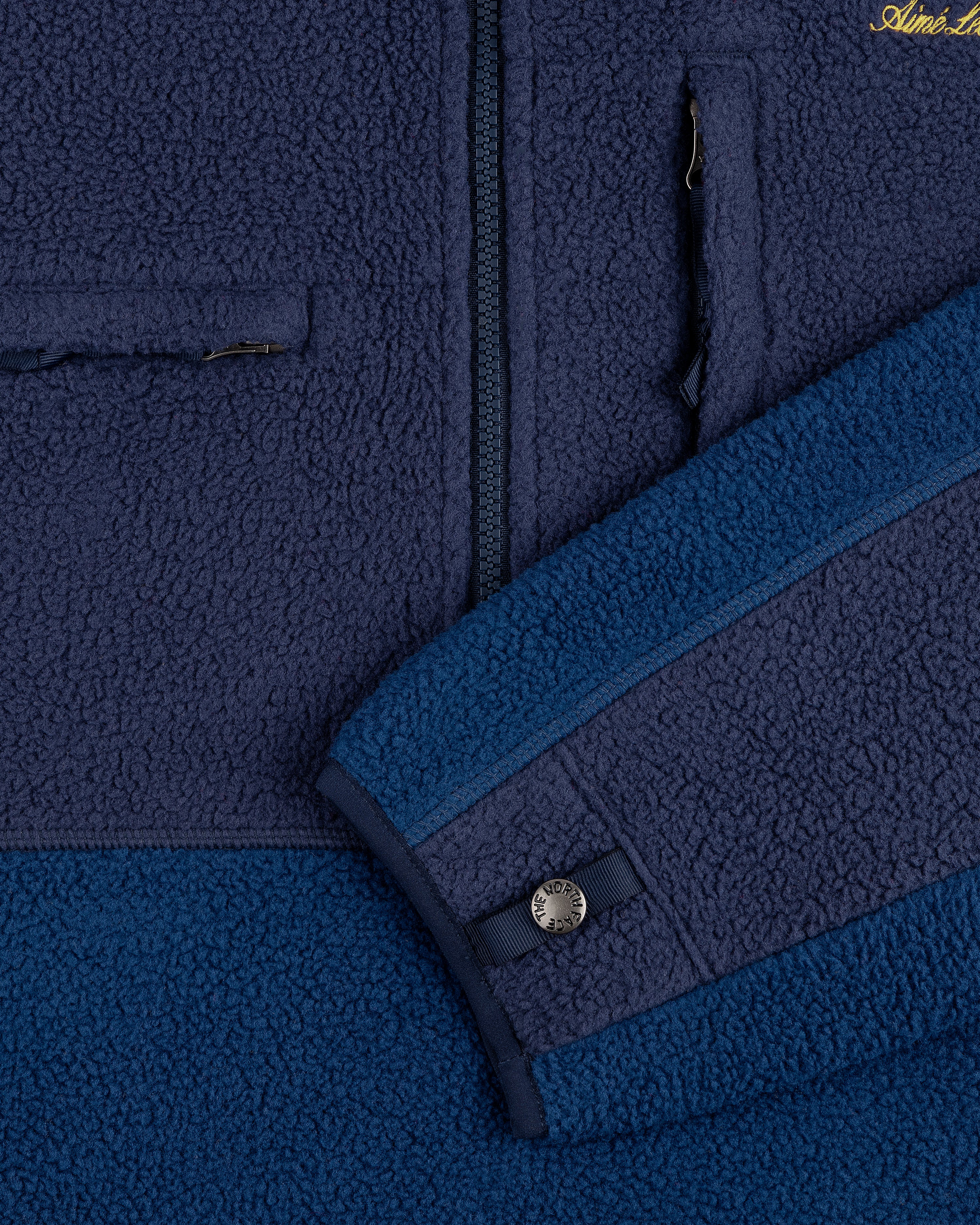 Close-up of the ALD/The North Face ’95 Denali Half-Zip Fleece Pullover, highlighting zipper pocket and sleeve button.
