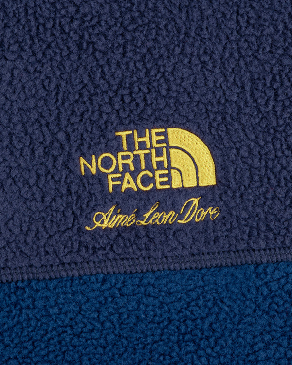 Close-up of ALD / The North Face ’95 Denali Half-Zip Fleece Pullover with yellow embroidered branding.