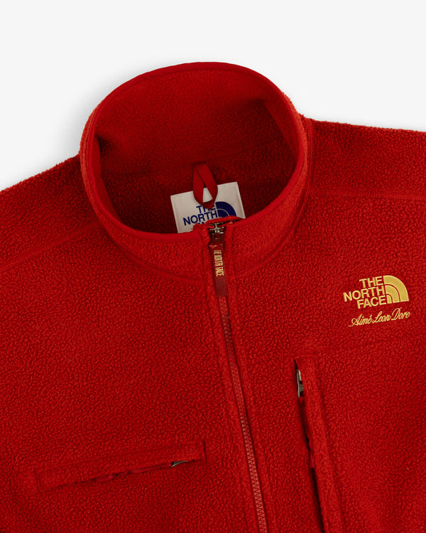 Red ALD/The North Face ’95 Denali Half-Zip Fleece Pullover with gold logo and chest zippers, top-front view.