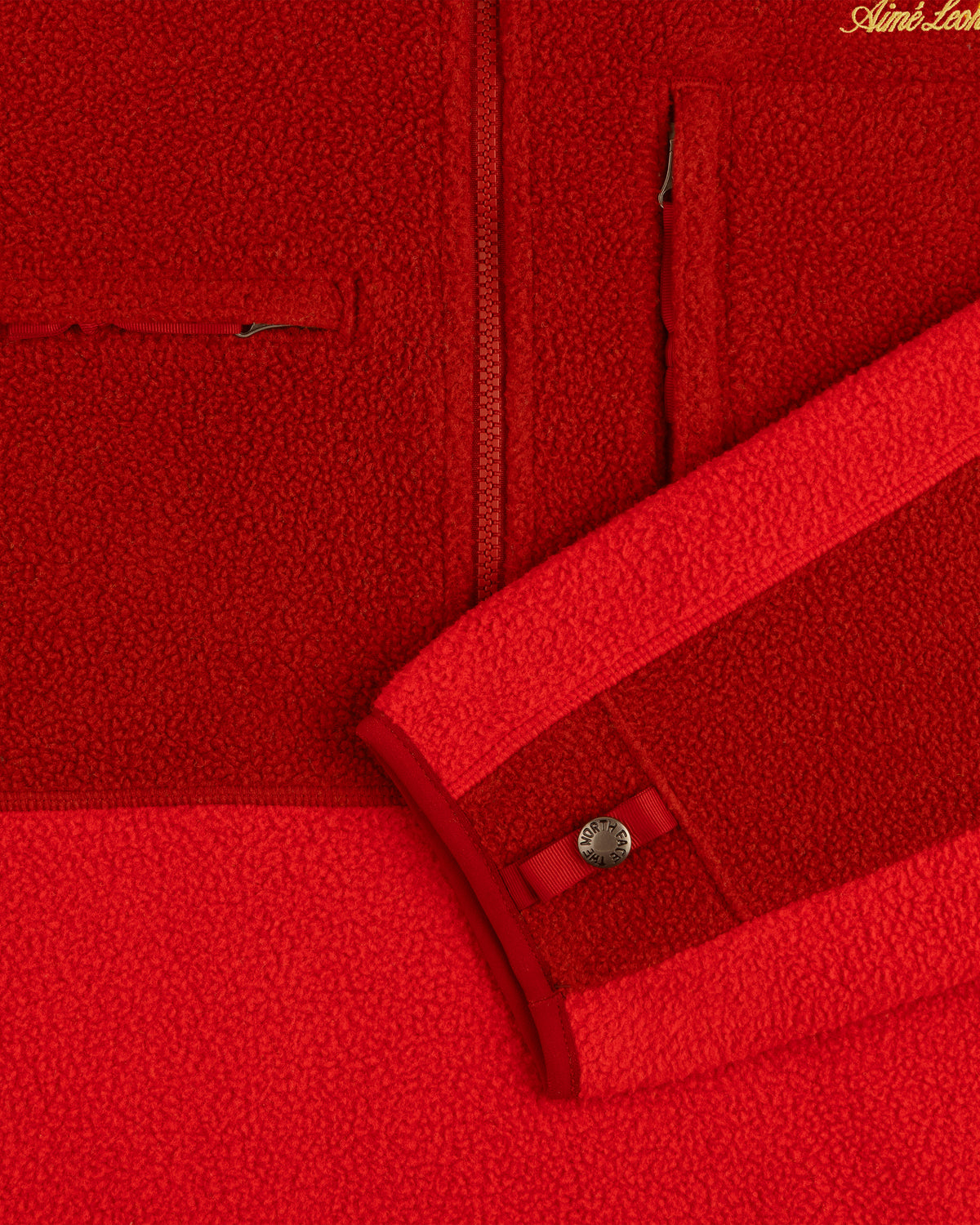 Close-up of the ALD/The North Face ’95 Denali Half-Zip Fleece Pullover showing a pocket, zipper, and snap cuff.