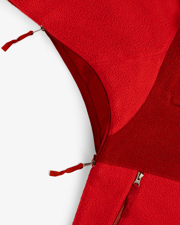 Close-up of the ALD/The North Face ’95 Denali Half-Zip Fleece Pullover, showing red fabric and two partially open zippers.