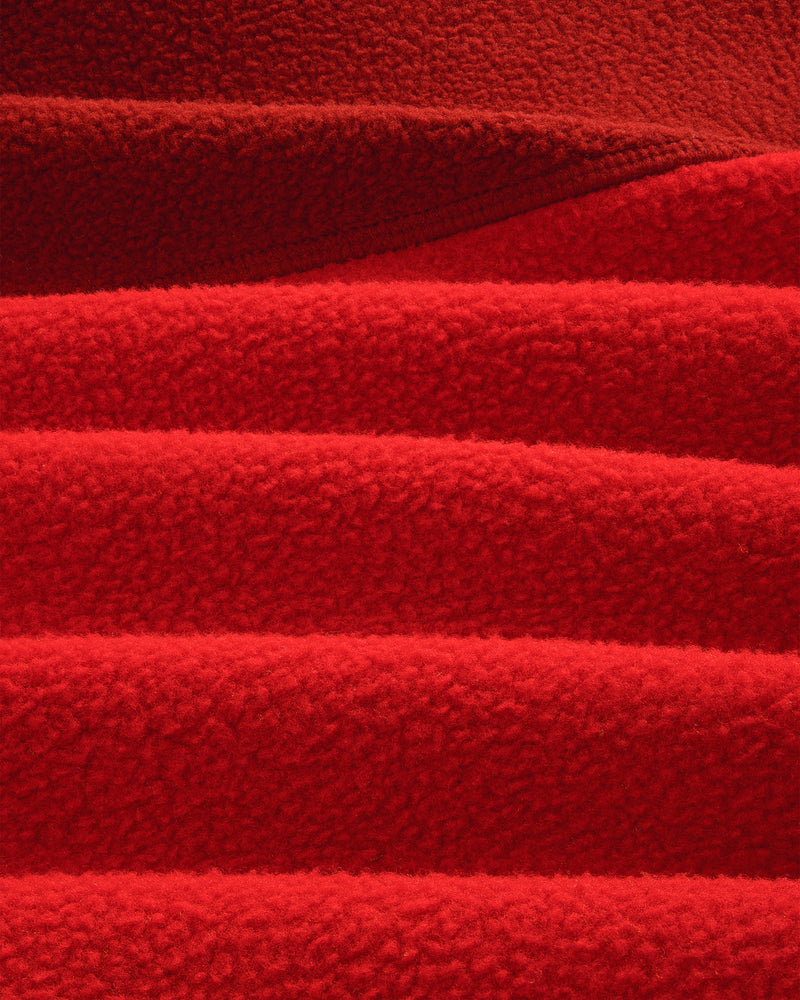 Detail of ALD / The North Face ’95 Denali Half-Zip Fleece Pullover: overlapping, textured red fleece with soft lines.
