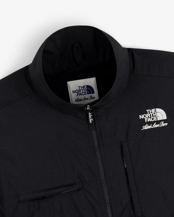 Close-up of a black ALD / The North Face Nylon Denali Jacket, featuring logo and zipper details.