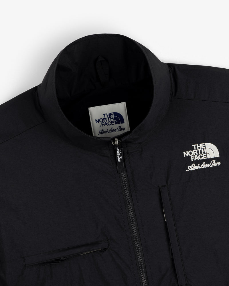 Close-up of a black ALD / The North Face Nylon Denali Jacket, featuring logo and zipper details.
