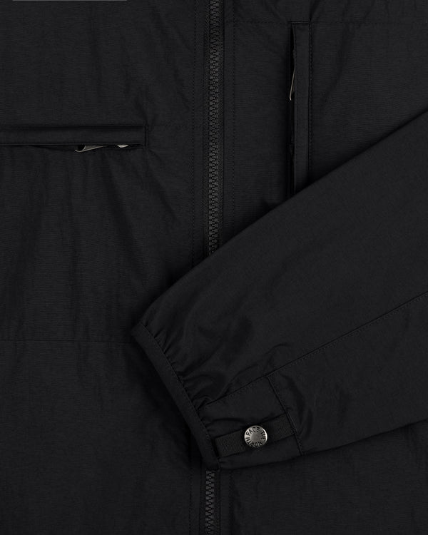 Close-up of ALD / The North Face Nylon Denali Jacket’s black sleeve with snap button cuff and zippered pockets.