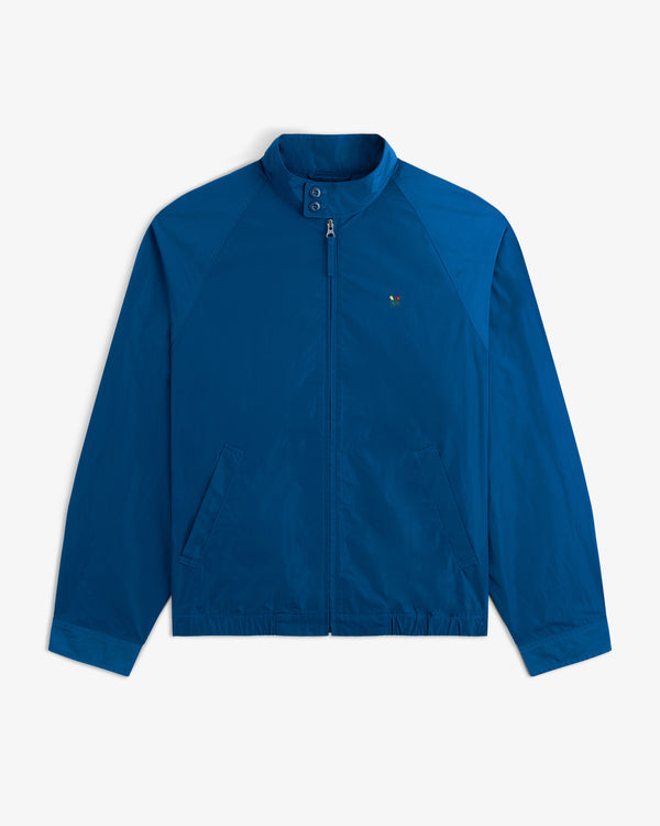 Crest Nylon Windbreaker: blue zip-up with stand collar, front pockets, and small chest logo.
