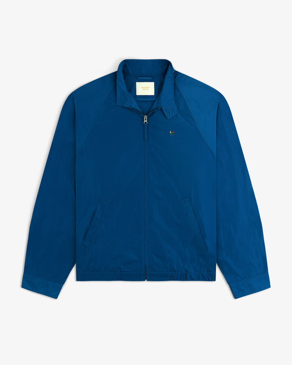 Crest Nylon Windbreaker: Blue zip-up with collar, side pockets, and left chest embroidered logo.