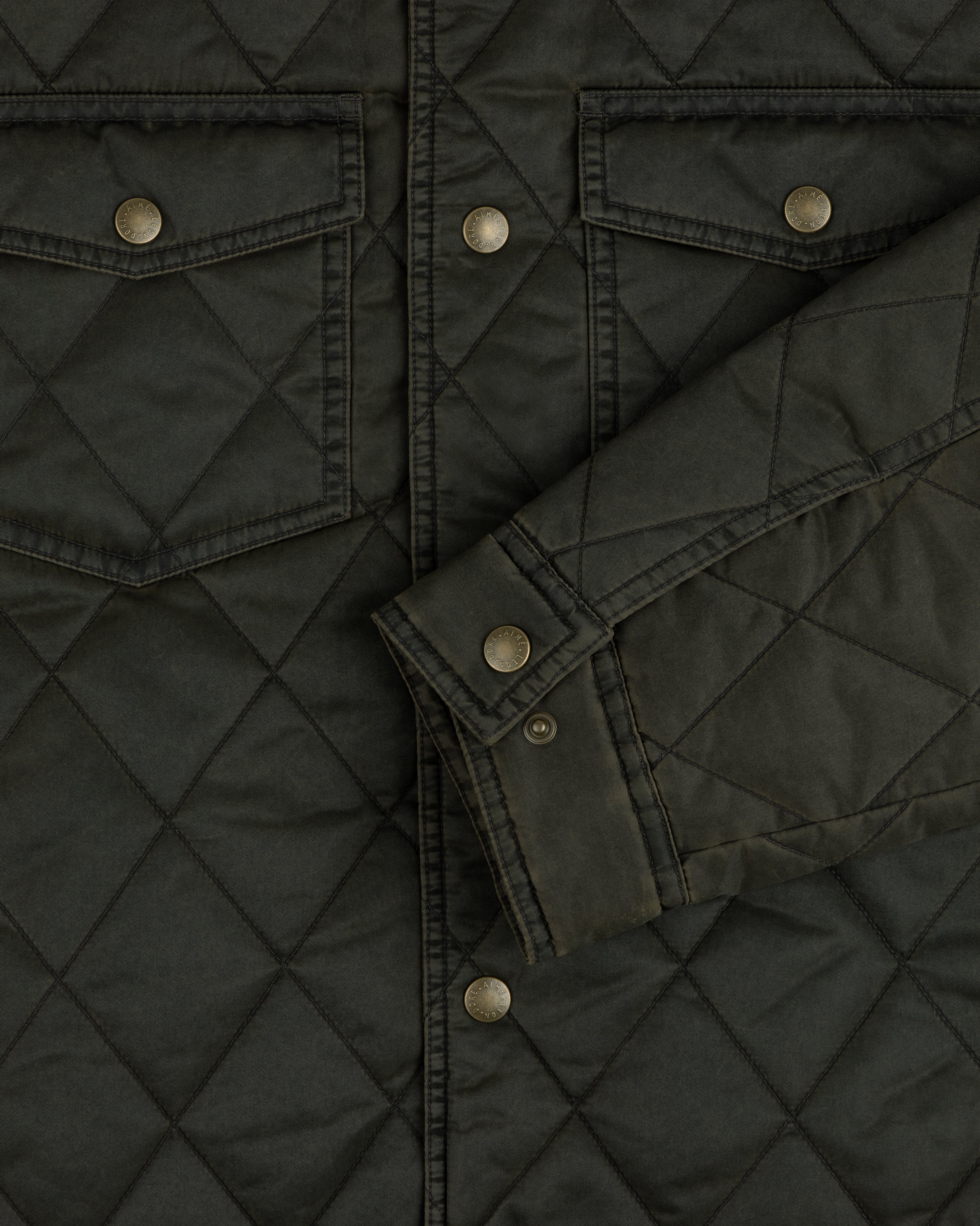 Dark olive quilted Quilted Trucker Jacket with chest pockets, metal buttons, and a buttoned cuff.