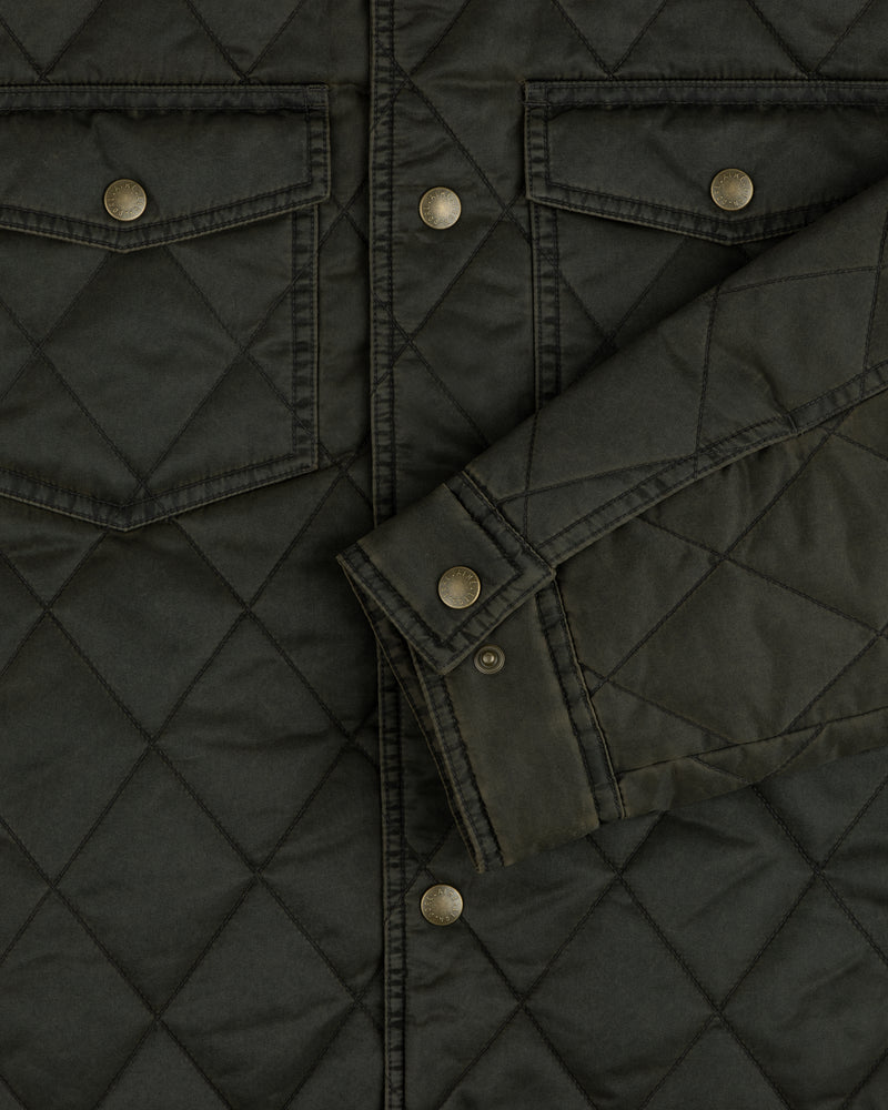 Dark olive quilted Quilted Trucker Jacket with chest pockets, metal buttons, and a buttoned cuff.