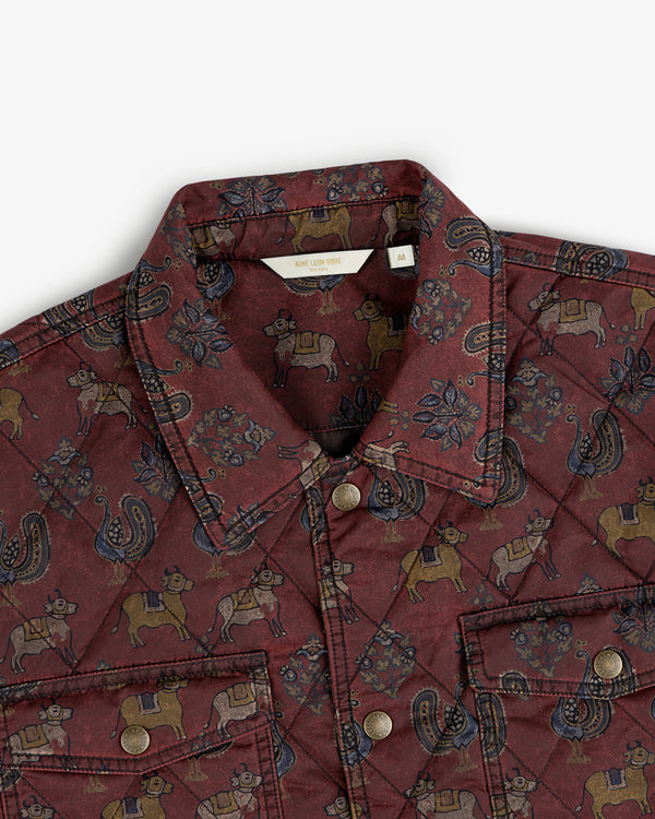 Maroon Quilted Trucker Jacket with a repeating cow and paisley pattern and metal button closures.