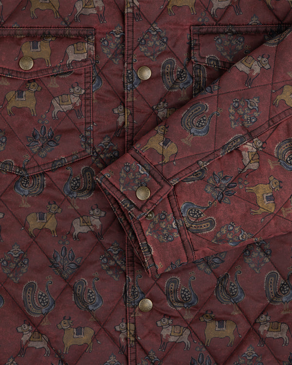 Quilted Trucker Jacket in deep red fabric with folk-style animals, plants, and metal buttons.