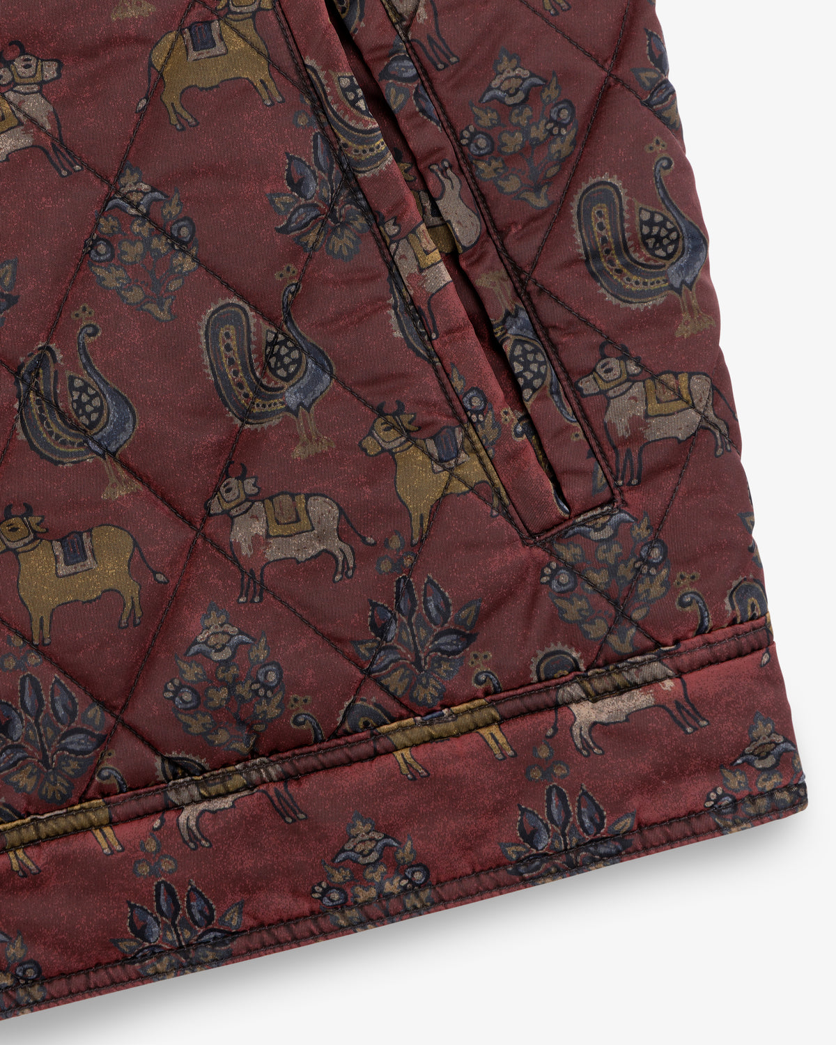 Maroon Quilted Trucker Jacket with a repeating pattern of animals and floral motifs.