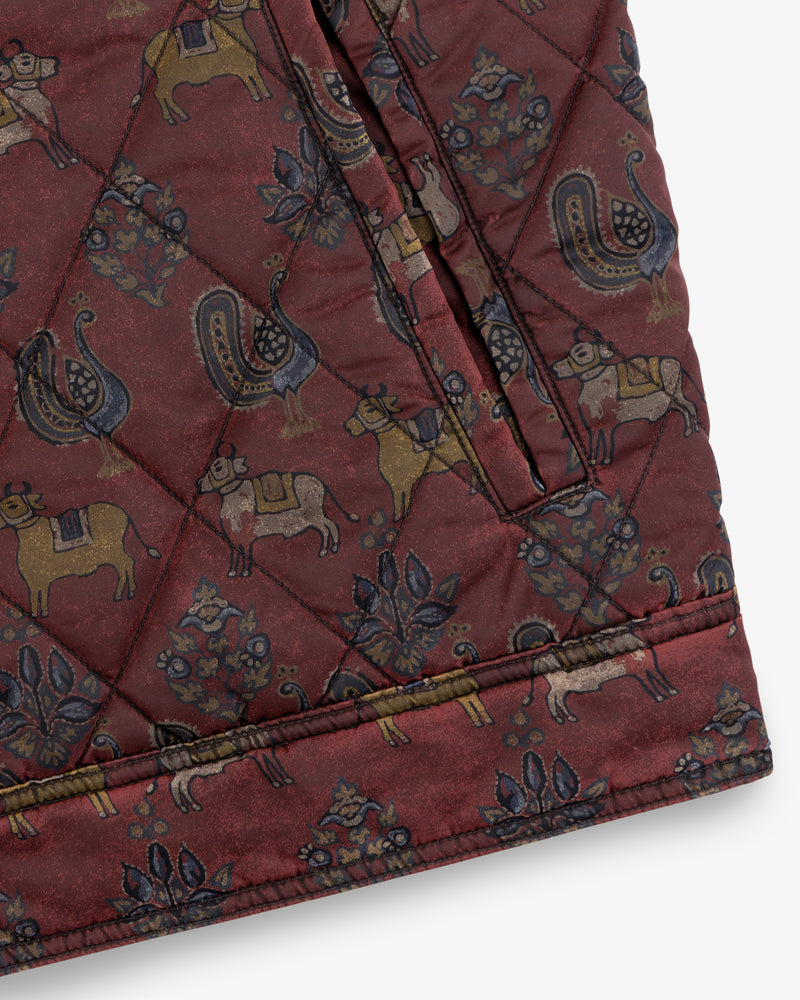Maroon Quilted Trucker Jacket with a repeating pattern of animals and floral motifs.