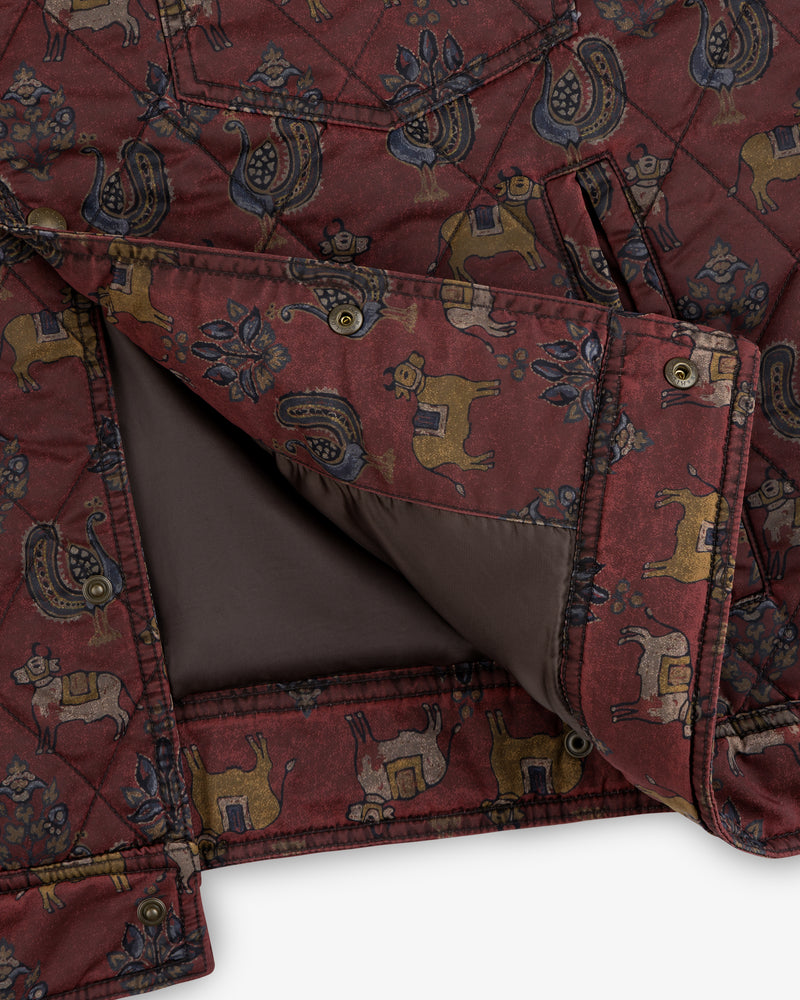 Close-up of a dark red Quilted Trucker Jacket featuring a repeating pattern of stylized roosters and cattle.