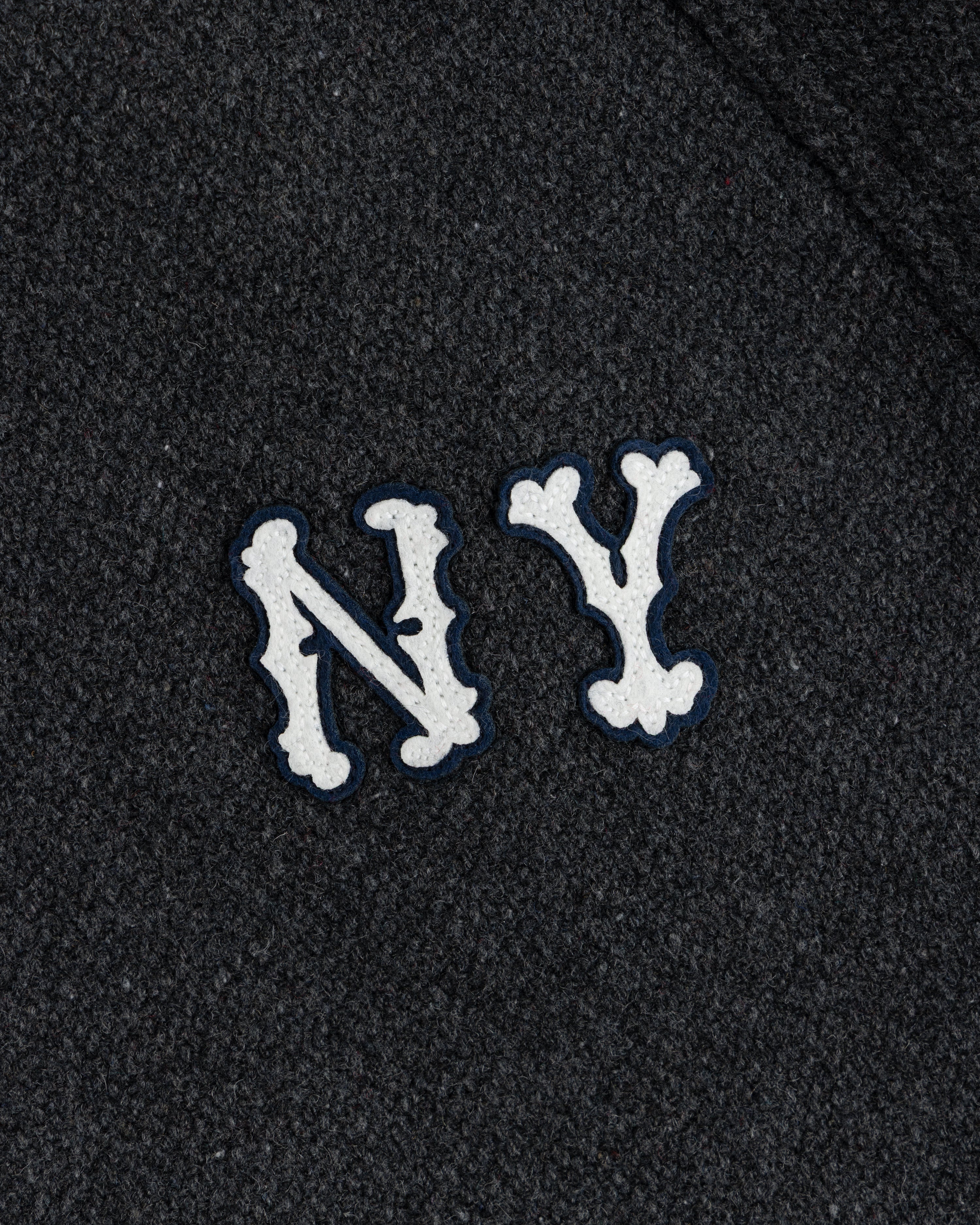 NY Highlanders Wool Varsity Jacket with white NY letters, blue outline on dark textured fabric.