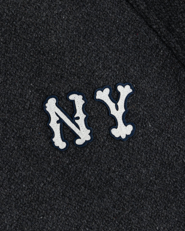 NY Highlanders Wool Varsity Jacket with white NY letters, blue outline on dark textured fabric.
