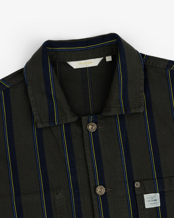 Close-up of a Striped Denim Chore Jacket with a collar and visible fabric label on the chest pocket.