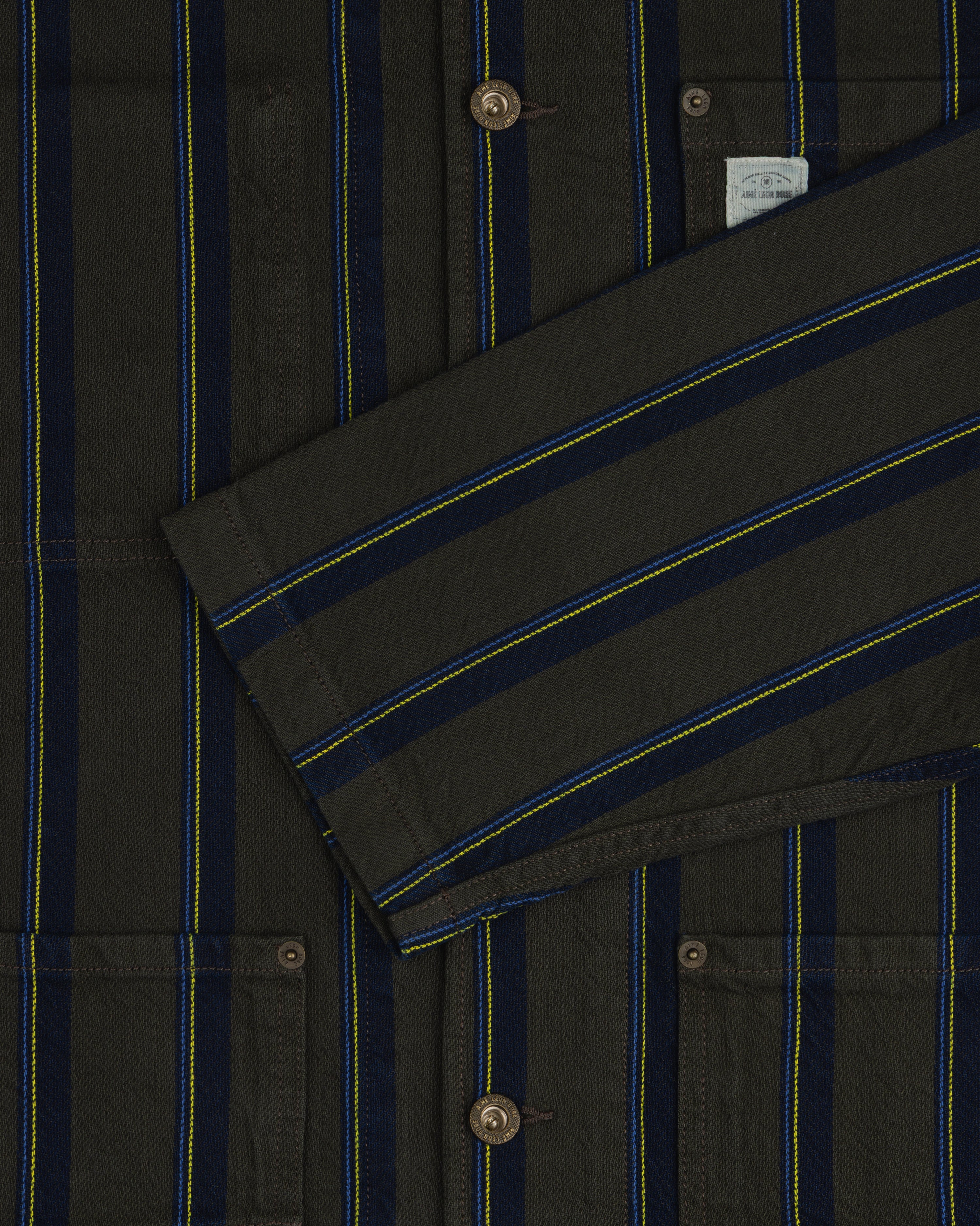 Striped Denim Chore Jacket with blue/yellow stripes, buttons, pockets, and a folded front sleeve.