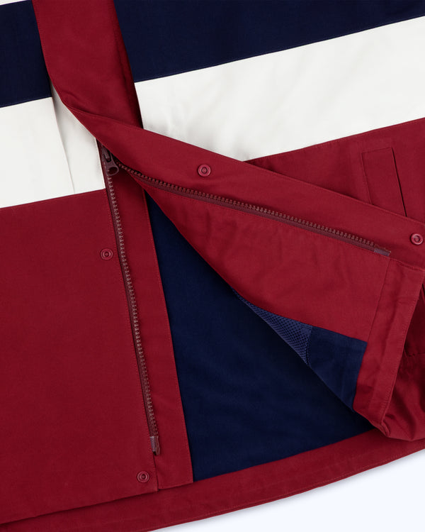 Close-up of the GORE-TEX Striped Sailing Jacket with maroon, navy, and white panels, open zipper, and lining.