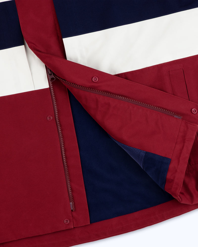 Close-up of the GORE-TEX Striped Sailing Jacket with maroon, navy, and white panels, open zipper, and lining.
