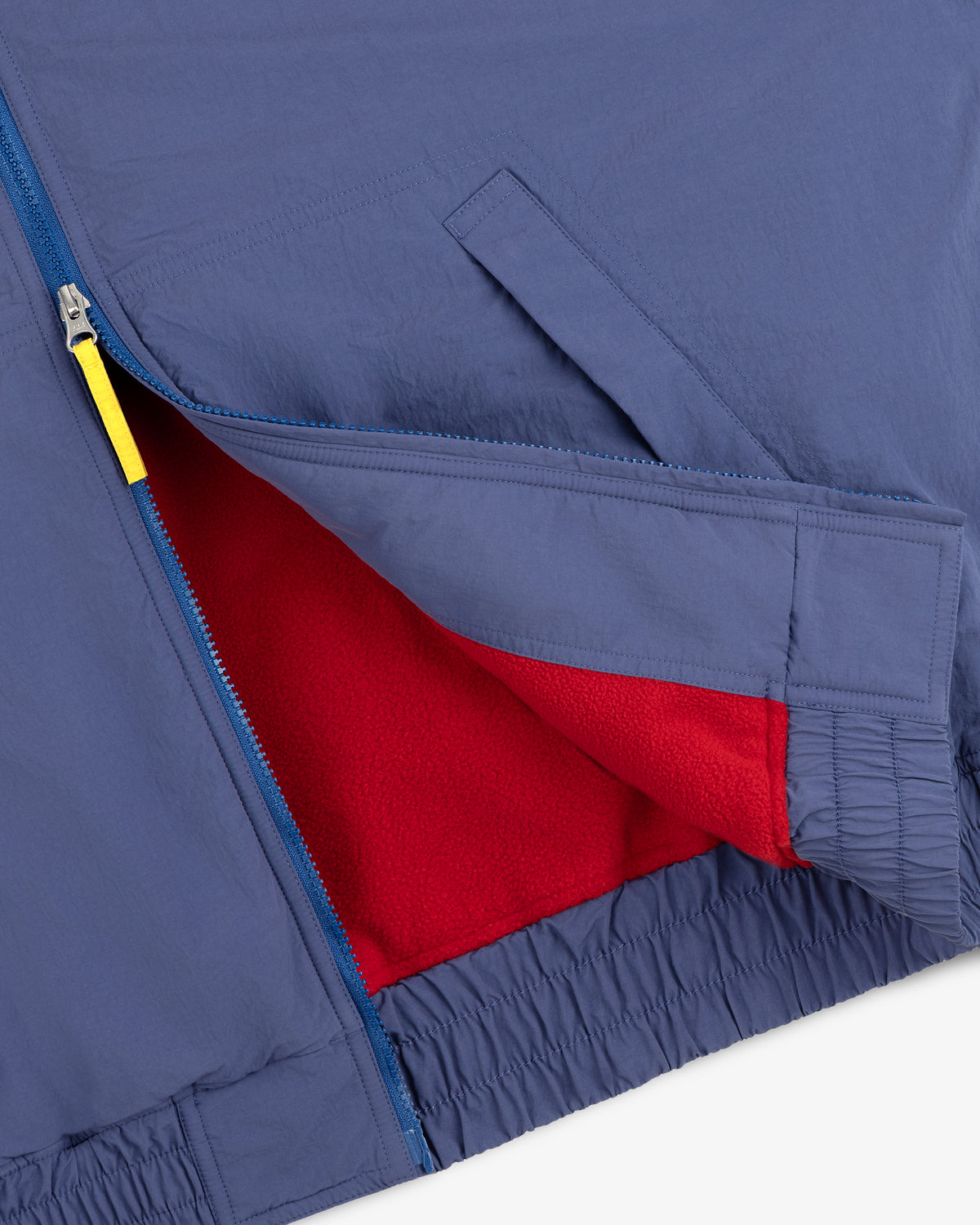 Fleece Lined Sport Windbreaker: blue, yellow zipper pull, red fleece lining, elastic waistband.