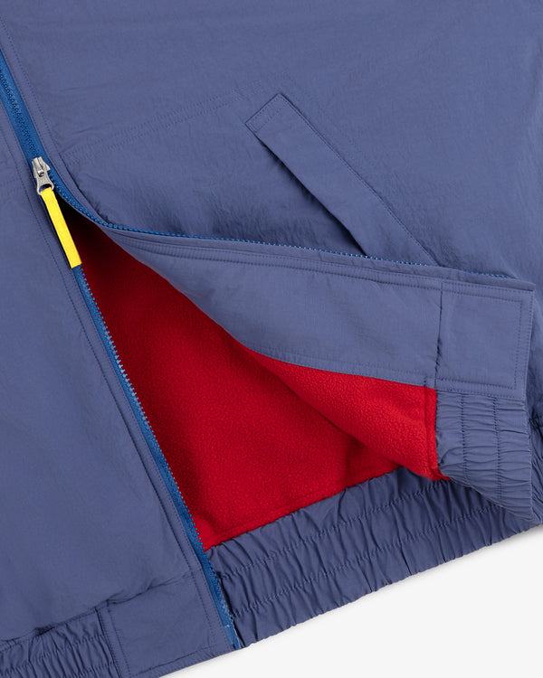 Fleece Lined Sport Windbreaker: blue, yellow zipper pull, red fleece lining, elastic waistband.
