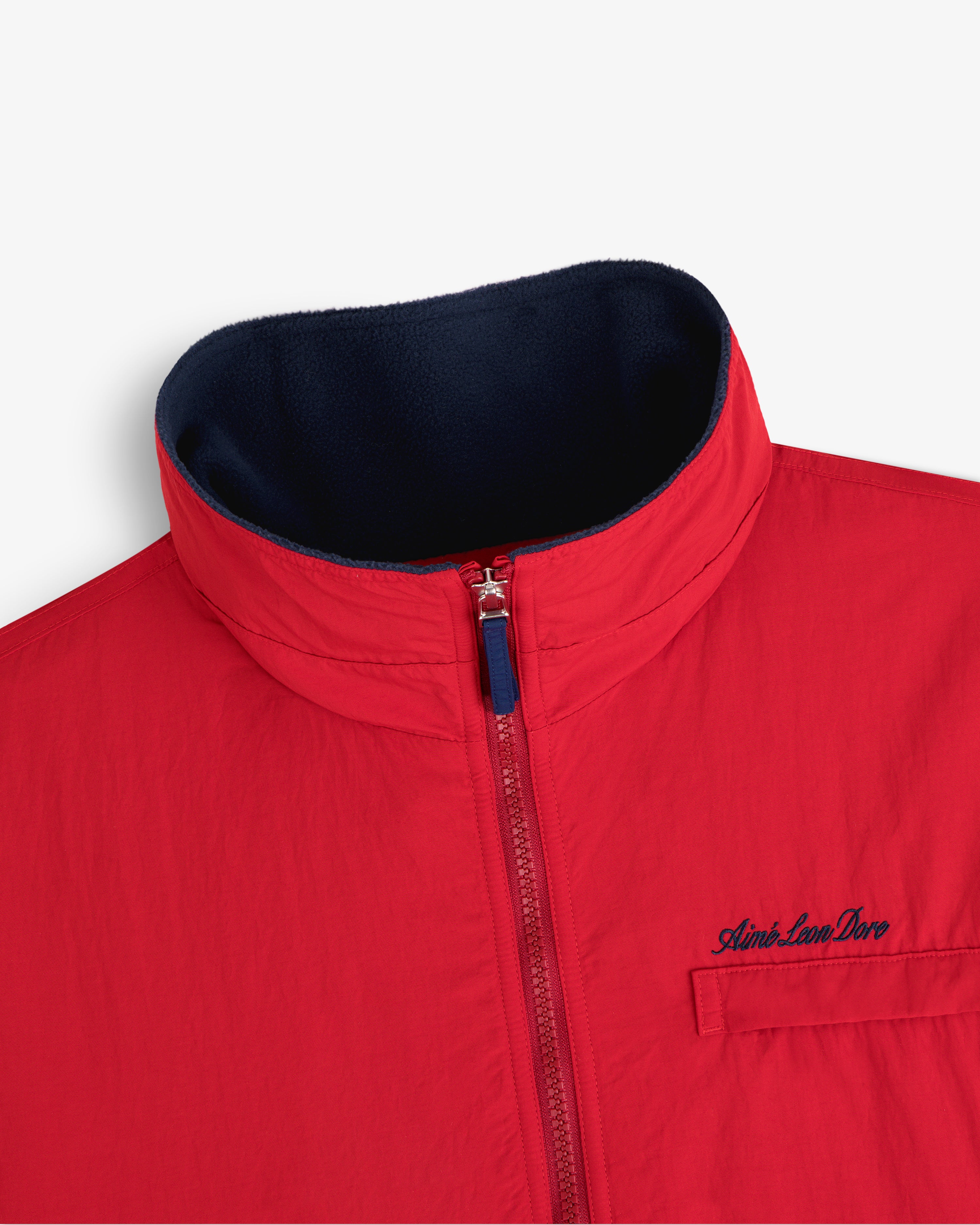 Fleece Lined Sport Windbreaker: red, zip-up front, high collar, chest pocket with small embroidered logo.