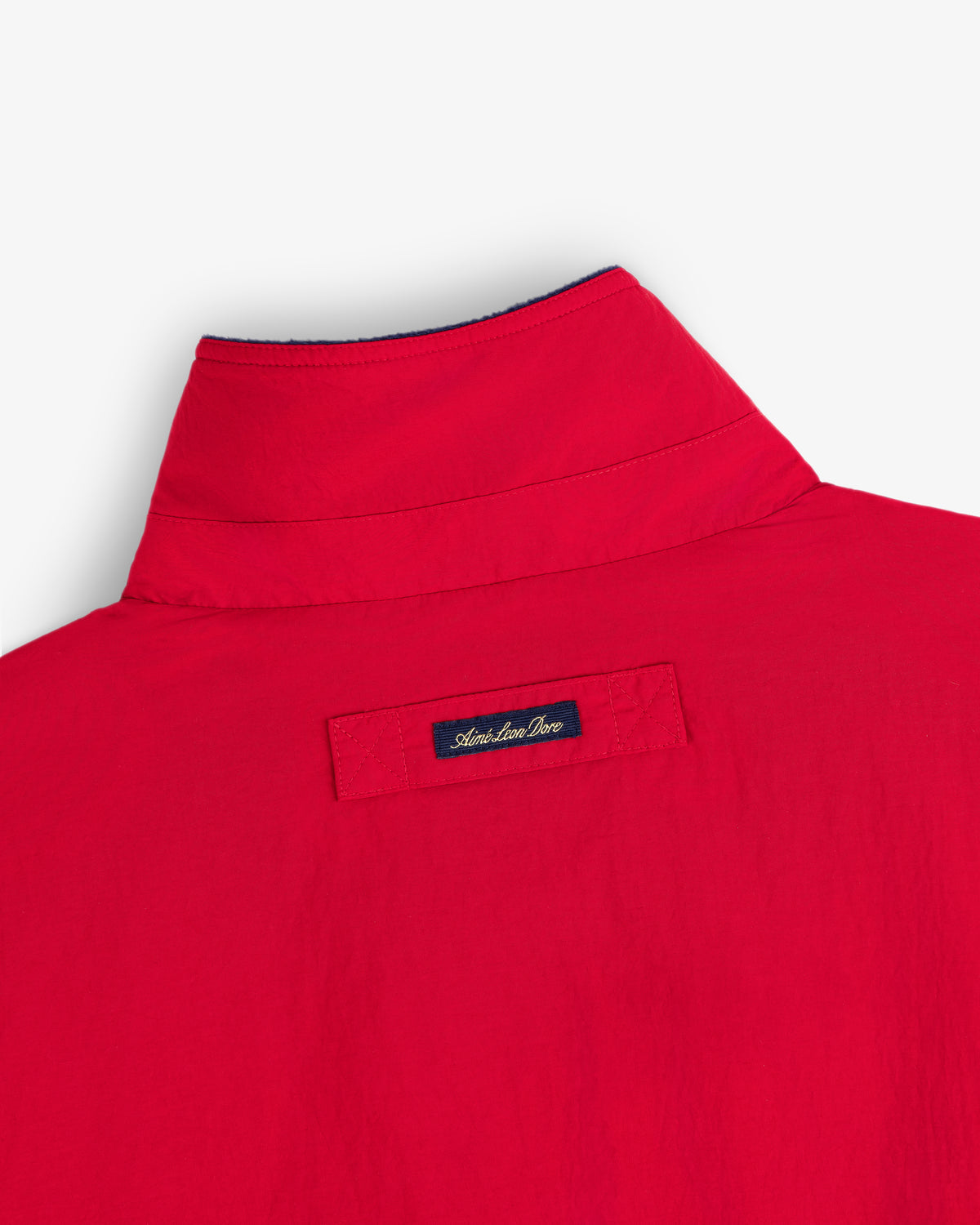 The back of a red Fleece Lined Sport Windbreaker with an Atlantique Pro label below the collar.