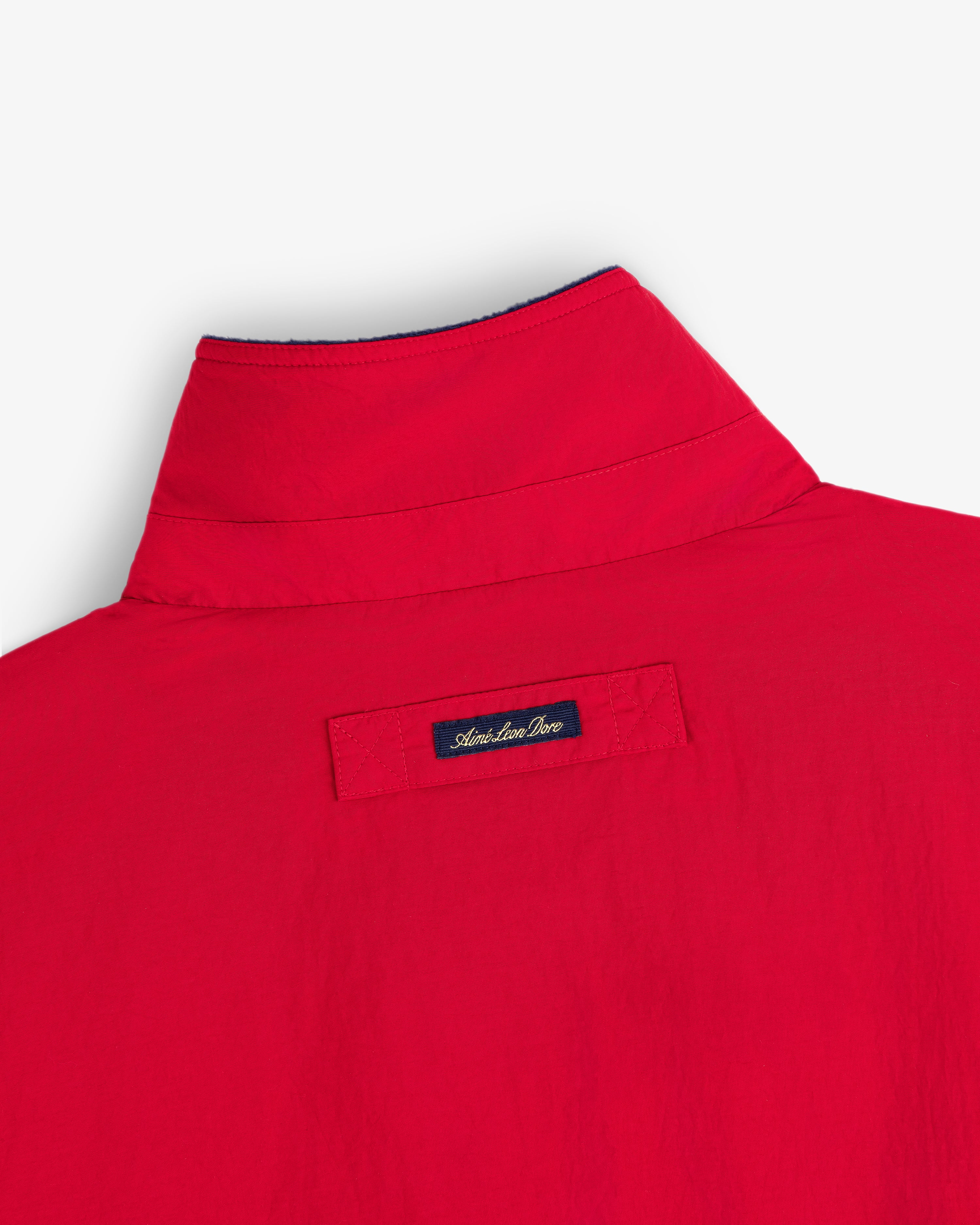The back of a red Fleece Lined Sport Windbreaker with an Atlantique Pro label below the collar.