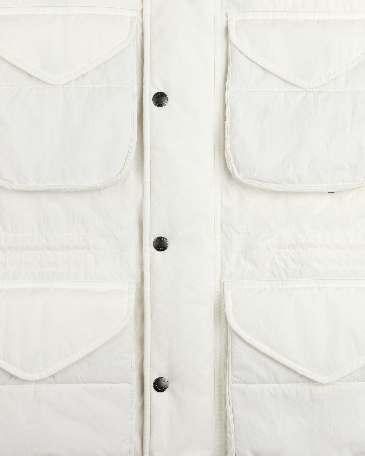 Close-up of a white Down-Filled Surplus Parka with four front flap pockets and a button-down placket.