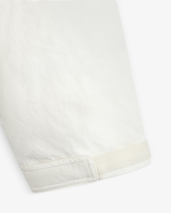 Close-up of a white Down-Filled Surplus Parka sleeve with a hook-and-loop adjustable cuff.
