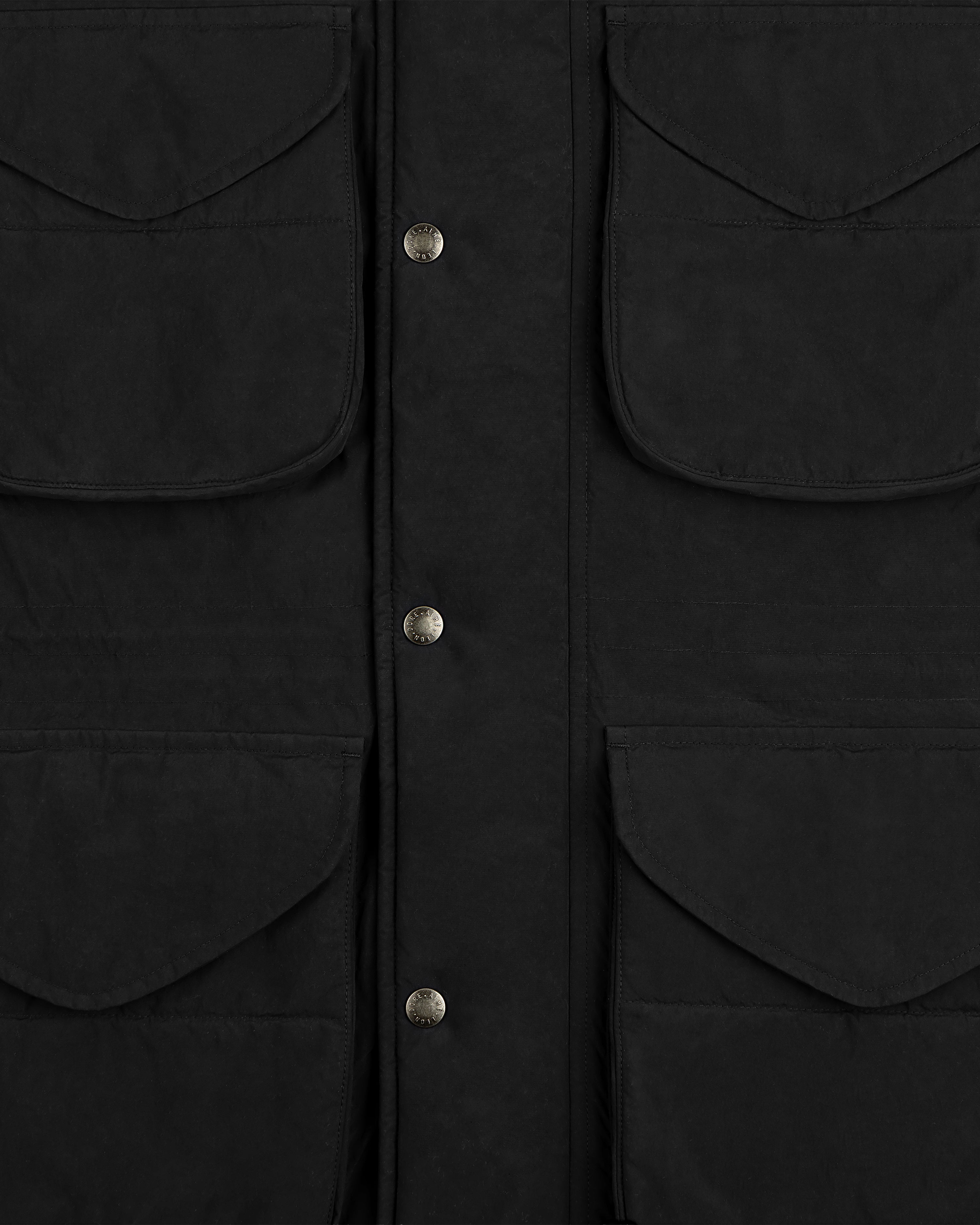Close-up of a black Down-Filled Surplus Parka with four large flap pockets and a central placket with metal snap buttons.
