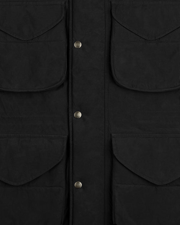 Close-up of a black Down-Filled Surplus Parka with four large flap pockets and a central placket with metal snap buttons.