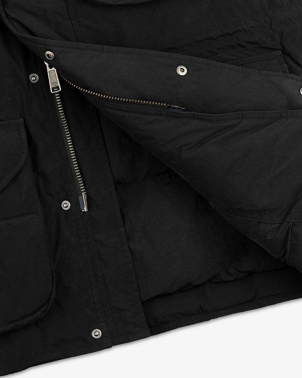 Close-up of a black quilted Down-Filled Surplus Parka with a metal zipper and snap button closures.