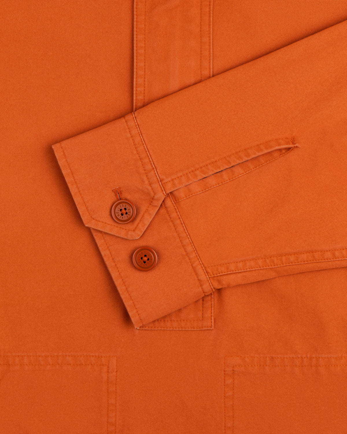 Garment Washed Anorak orange long-sleeve shirt cuff with two matching buttons.