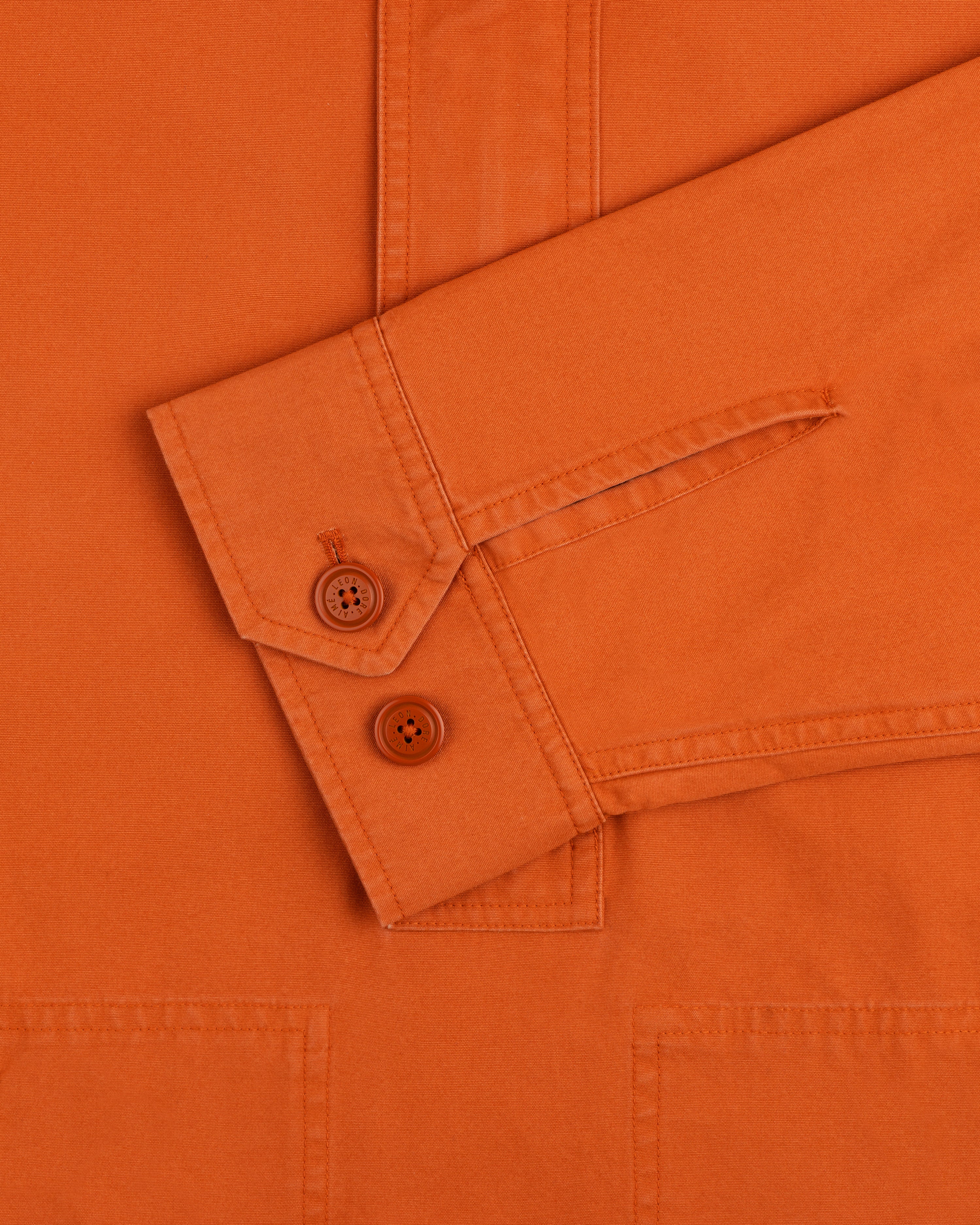 Garment Washed Anorak orange long-sleeve shirt cuff with two matching buttons.